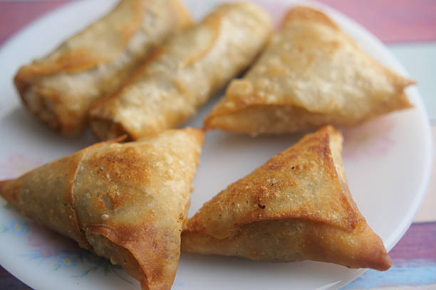 istock Crispy samosas served on a plate in a colorful setting 2232580638