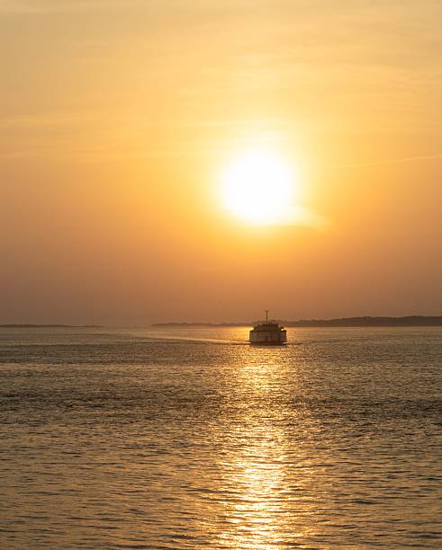 istock Serene sunset over ocean with ferry silhouette. 2232587545