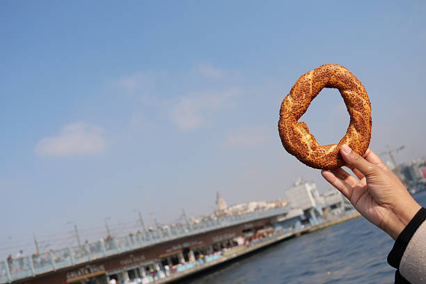 istock Enjoying a simit by the waterfront in a bustling city 2232587667