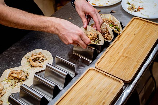 istock Close-up of man preparing tacos at restaurant 2232588990
