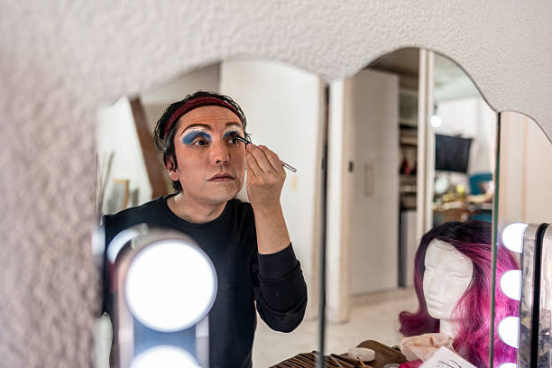 istock Mature man putting on makeup at home 2232592736