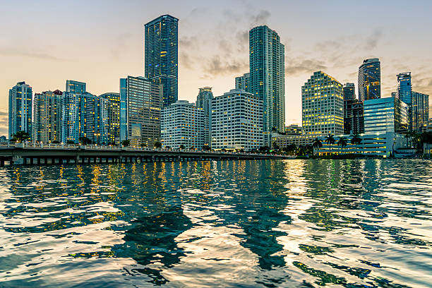 istock Modern City Skyline at Sunset Reflected on Water in Miami, Florida 2232599736