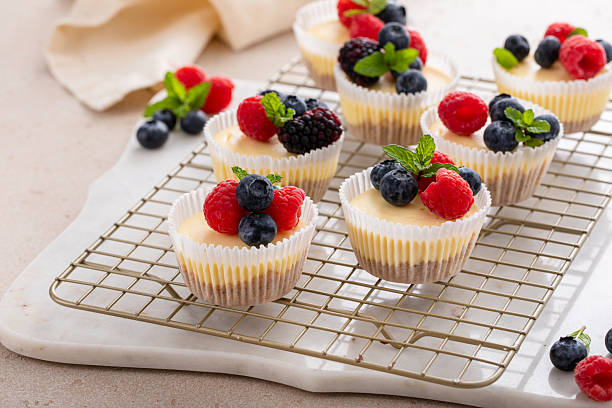 Mini cheesecakes baked in a muffin pan topped with fresh berries