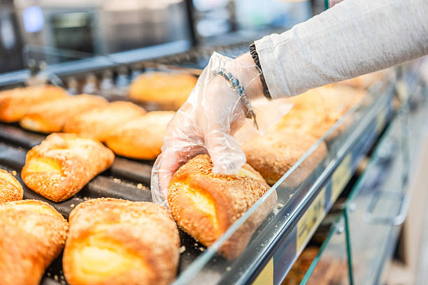 istock Girl Picking Up Buns At Supermarket 2232600653