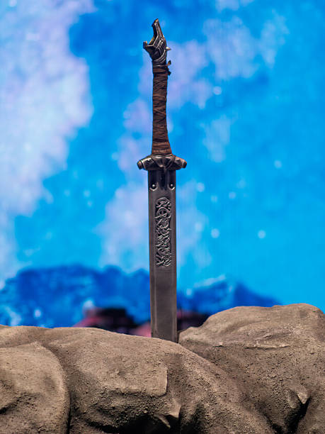 istock Legendary Sword of Power Stands Proudly on Stone 2232608041