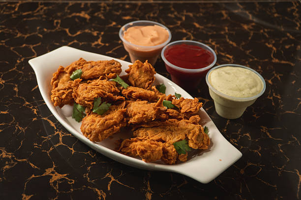istock Fried chicken on a plate with sauces around it. 2232608731