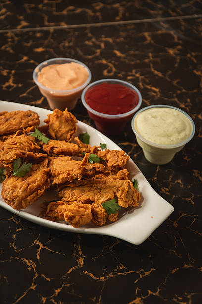 istock Fried chicken on a plate with sauces around it on a graphite table. 2232608866