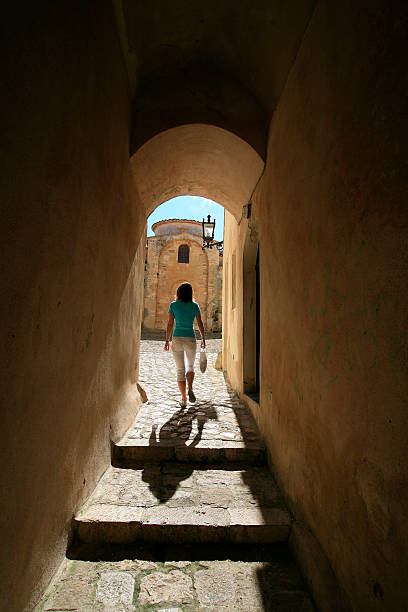 istock Lady walking through archway in Otranto, Puglia. 2232611120
