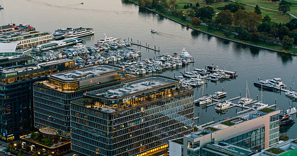 Helicopter shot of moored boats and the modern apartment buildings of the District Wharf, a mixed-use development on the Southwest Waterfront in Washington, D.C. on a clear evening in fall.