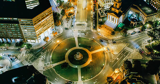 Helicopter shot of office buildings and traffic on the illuminated streets of Downtown Washington, D.C. at night.