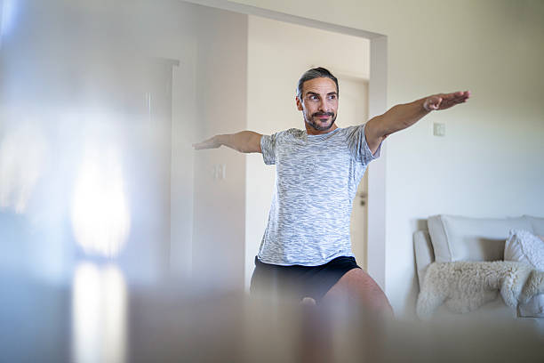 istock Man stretching and exercising indoors. 2232614879