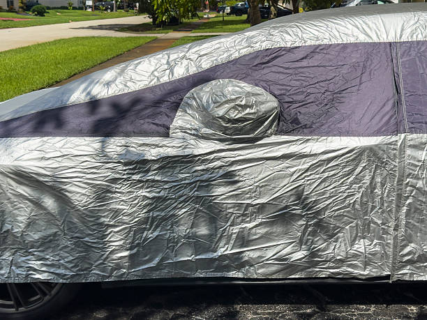 istock Car Covered with Protective Cover in Residential Driveway 2232617790