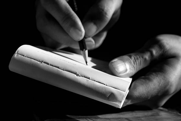istock Close Up of Hand Writing with Pencil on Notebook in Black and White 2232618959