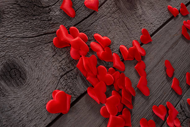 istock Red Fabric Hearts Scattered on Rustic Wooden Surface for Romantic Decor Theme 2232618998