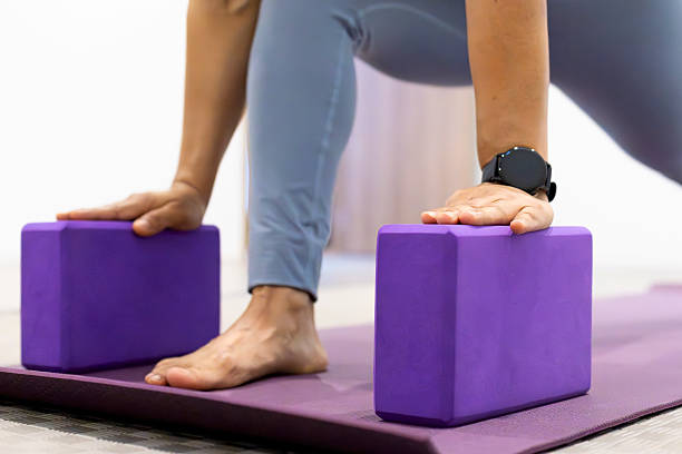 istock Woman performing a variation low lunge pose with blocks 2232621130