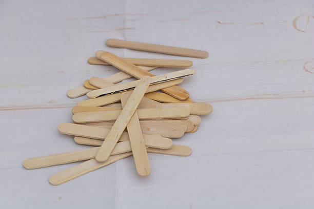 istock Wooden craft sticks scattered on light background for DIY projects 2232624327