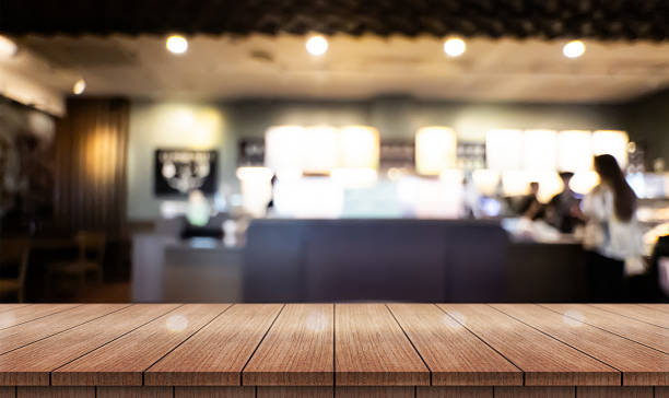 istock Empty wooden table top with lights bokeh on blur restaurant background. 2232624851