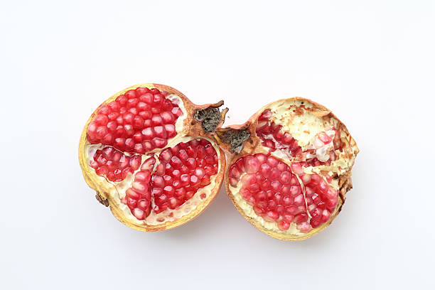 Top view of a pomegranate fruit separated in half on a white background