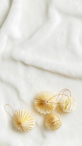 istock Minimal style winter holidays top view composition with New Year paper festive ornaments cream beige Christmas balls on White Fur Texture background, copyspace. Neutral tones, phone format 2232628406