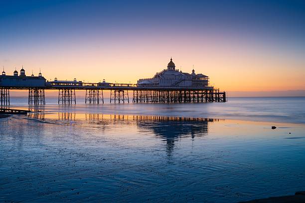 istock Pier at sunrise with calm sea reflections 2232631267
