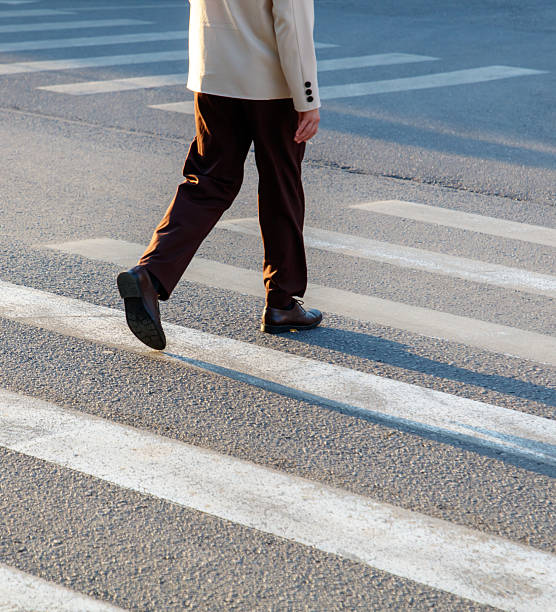 istock A man is walking across a crosswalk 2232631712
