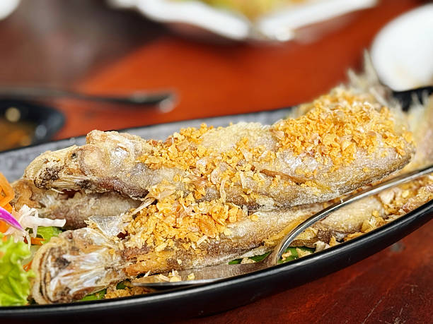 istock Fried fish with vegetable in thai style on the table. 2232632835