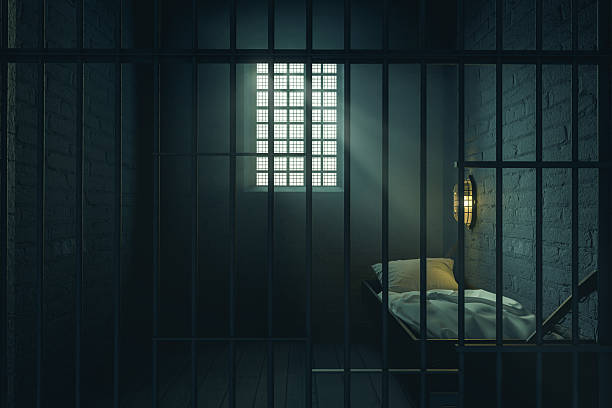 istock 3D Rendering of old prison cell with lighting behind the bars. A 2232640849