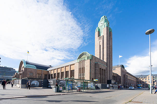 Helsinki Central Railway Station Finland Facade with Art Deco Sculptures - Lyhdynkantajat Sculptures holding copper and glass orbs at the walls of Helsinki Central Station. Monumental Art Deco statues, designed and completed in the year 1914. The Lyhdynkantajat Statues are part of the facade of the Art Nouveau Helsinki Central Station. 100 MPixel Hasselblad X2D Architecture Shot. Helsinki, Finland, Scandinavia, Northern Europe