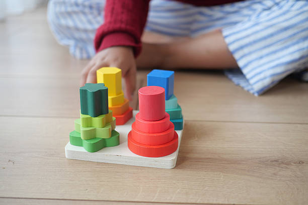 istock Child engaging with colorful stacking toy in playroom 2232643261