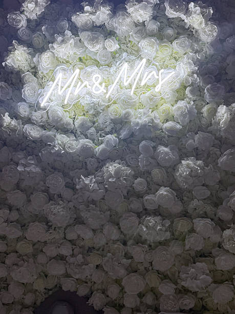 istock Romantic Mr and Mrs Neon Sign on White Rose Wall 2232643262