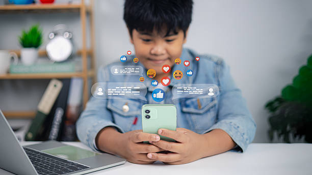 istock Asian boy using smartphone with social media icons and online communication concept 2232647460