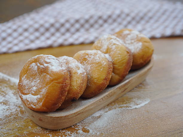istock Homemade Fried Donuts with Powdered Sugar Topping on Wooden Tray 2232648112