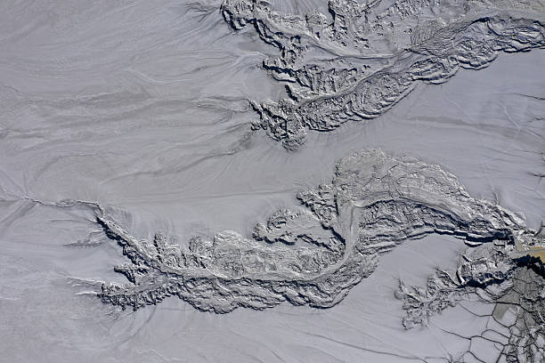 Aerial view of gray abstract mud patterns and cracks on acid mine drainage surface by drone
