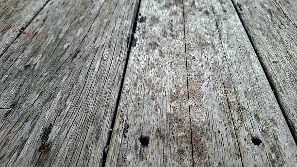 istock Weathered Wooden Planks with Grain Patterns and Nail Holes 2232654332