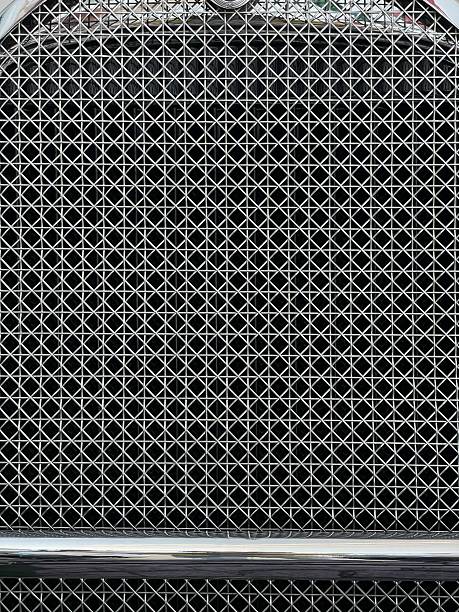 istock Intricate Metallic Grid Pattern of a Car Grille 2232660110
