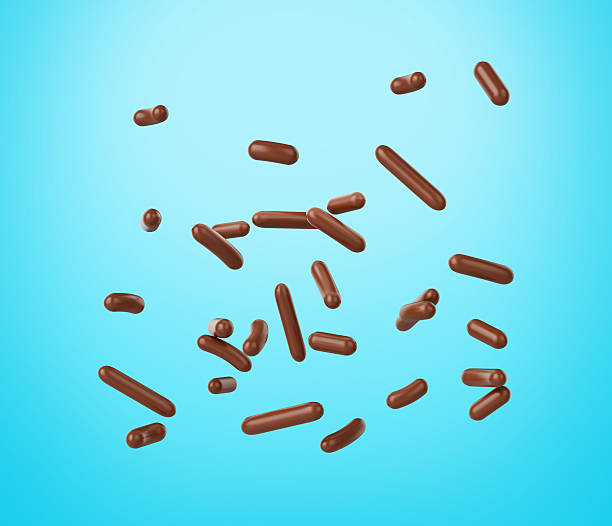 istock Chocolate Sprinkles For Cakes, Ice Cream And Desserts Falling On blue Background 3D Illustration 2232661582