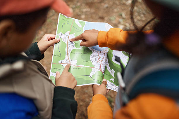 istock Children Exploring Map Together during Outdoor Adventure Activity 2232661817