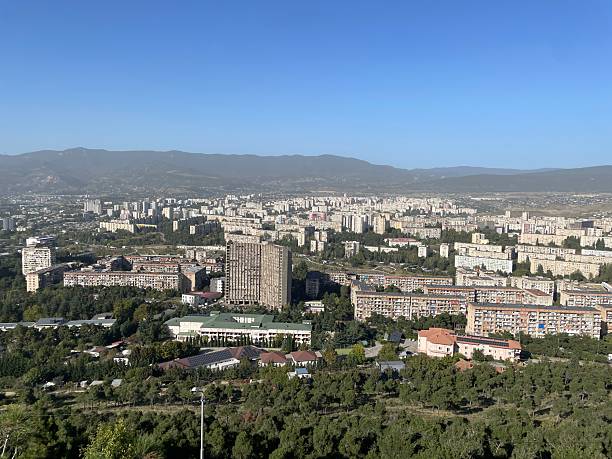 istock Vast Cityscape with Distant Mountains Under Clear Blue Sky. 2232661979