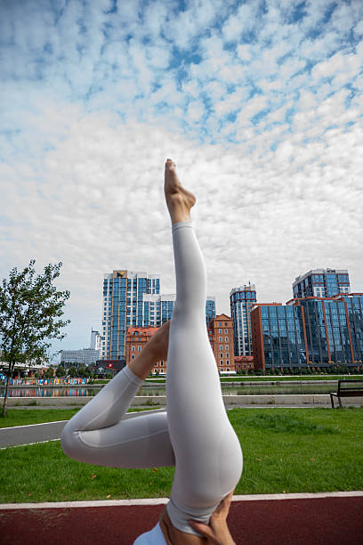 istock A young woman in a light-colored tracksuit is exercising outdoors on a summer day 2232662205