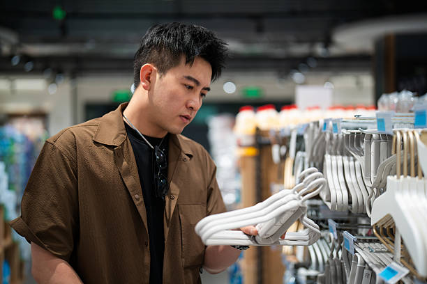 istock Asian man buying cothangers in supermarket 2232665150