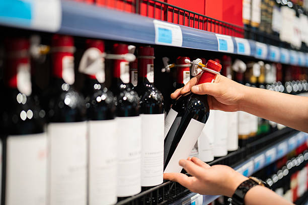 istock Asian man buying wine in supermarket 2232665325