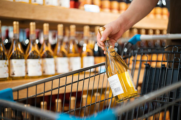 istock Asian man buying wine in supermarket 2232665370