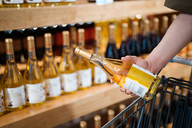 istock Asian man buying wine in supermarket 2232665373