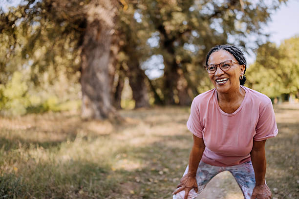 istock Smiling mature woman taking a break from running at public park 2232667940