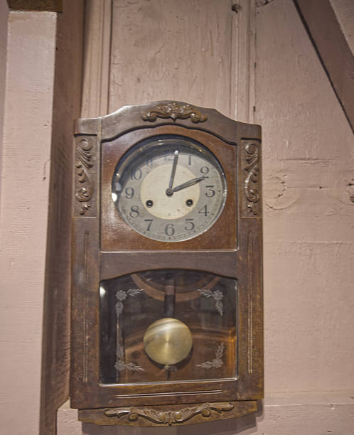 istock Antique wall clock in a wooden case 2232672855
