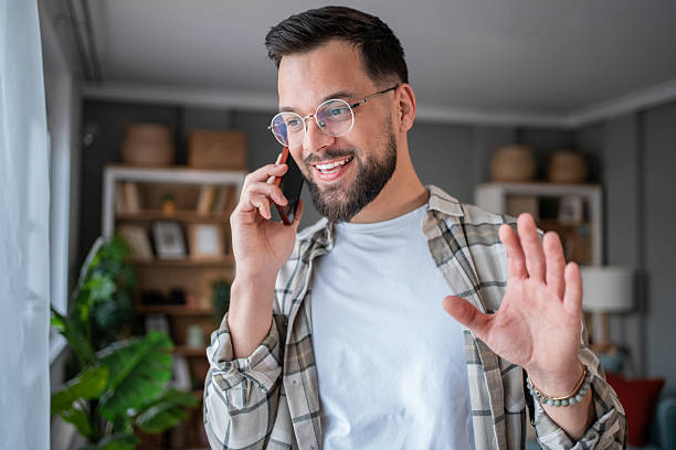 istock Young man talking on phone and gesturing in home office 2232673130