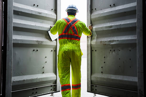 istock Engineers team or shipyard officers inspecting a containers in container yard. 2232674311