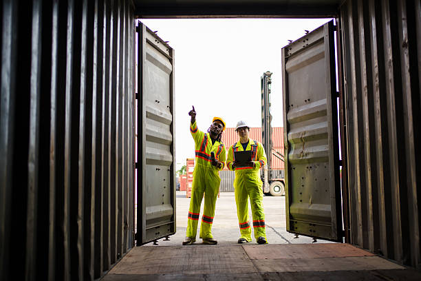 istock Engineers team or shipyard officers inspecting a containers in container yard. 2232674313