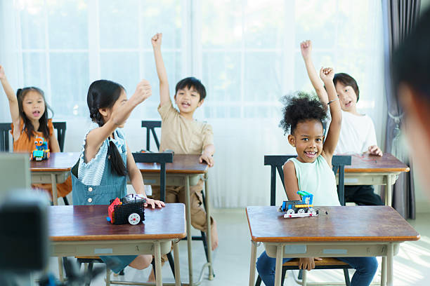 A group of diverse ethnicity children are enjoy learning in STEM classroom. STEM stand for science, technology, engineering, and mathematics is help to develop learning skills and talents in children.