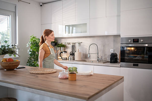 istock Woman cooking checking oven in modern kitchen at home 2232676977